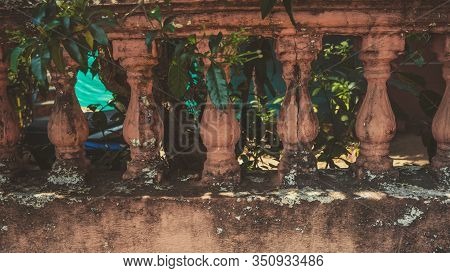 Close Up Of Old Cracked Fence. Interesting Architectural Structure With Peeling Paint. Green Tree Br