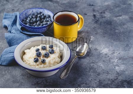 Milk Rice Porridge With Blueberry, Creamy Rice Pudding Or French Riz Au Lait In A Metal Bowl And Ena