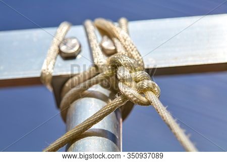 A Rope Is Knotted To A Strut Of Aluminum.