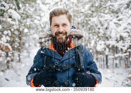 Cheerful Tourist Smiling In Winter Snow-clad Forest