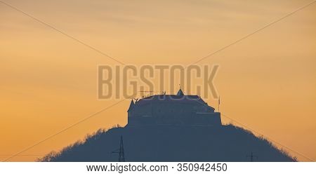 Old Castle Silhouette On The Hill At Dawn. Famous Palanok Castle In Transcarpatia, Ukraine.