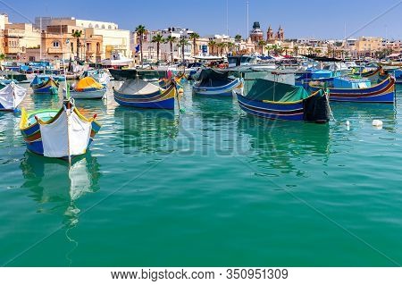 Multicolored Fishing Boats Luzzu With Eyes In The Harbor. Marsaxlokk. Malta.