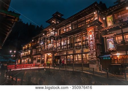 Tourists Are Traveling The Famous Ginzan Onsen While Snow Is Falling Down.