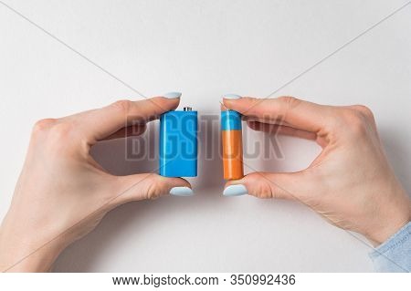 Women Hands Holding Generic Aa And Pp3 Batteries. Accumulator On White Background