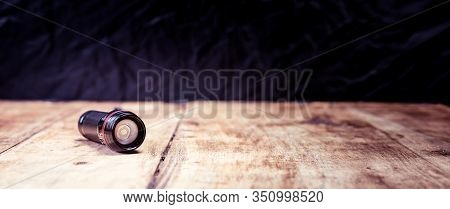 Small Pocket Led Torch Isolated On Wooden Table