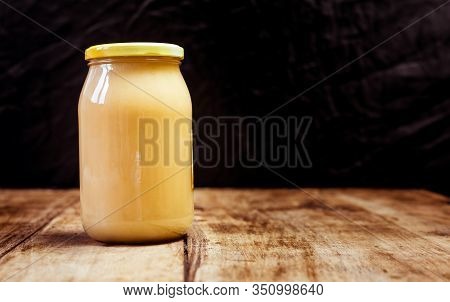 Homemade Jar Of Fresh Natural Honey Isolated On Vintage Wooden Board