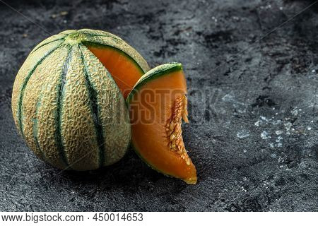 Cantaloupe Melon. Whole And Slice Of Japanese Melons, Orange Melon With Seeds On Dark Background. Pl