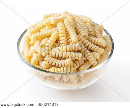 Uncooked Fusilli Corti Bucati Pasta In Glass Bowl Isolated On White Background With Clipping Path