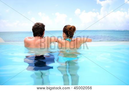 Par søger på havet fra swimmingpoolen