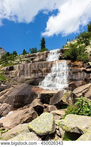 Summer Landscape With A Cascade Of Waterfall On Huge Stone Run. Waterfall Marble In The Ergaki Natur