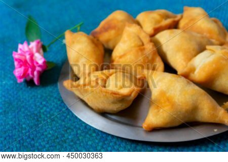 Blurred Image Of Homemade Samosa, Samsa Or Smosa. A Vegetarian Spicy Indian Special Traditional Stre