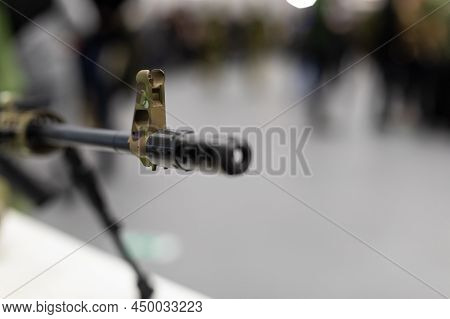 The Muzzle With The Sight Of An Army Assault Rifle Is Pointed At The Camera. Close-up Of The Weapons