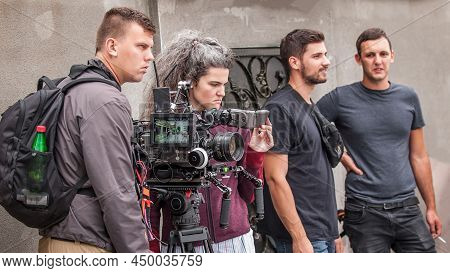 Behind The Scenes. Film Crew Team Shooting Movie Scene On Outdoor Location. Group Filmmaking Set Pro