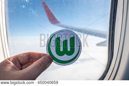 December 6, 2021. Wolfsburg, Germany. The Emblem Of The Football Club Vfl Wolfsburg On The Backgroun
