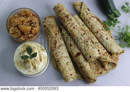 Indian Flat Bread Made Of Whole Wheat Flour, Grated Zucchini And Coriander Leaves. Served With Spice