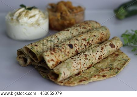 Indian Flat Bread Made Of Whole Wheat Flour, Grated Zucchini And Coriander Leaves. Served With Spice