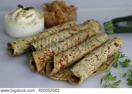Indian Flat Bread Made Of Whole Wheat Flour, Grated Zucchini And Coriander Leaves. Served With Spice