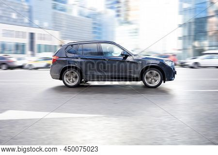 Fast Moving Bmw X3 F25 On The City Road. Black Suv With Man Driving. Luxury Auto In Fast Motion With