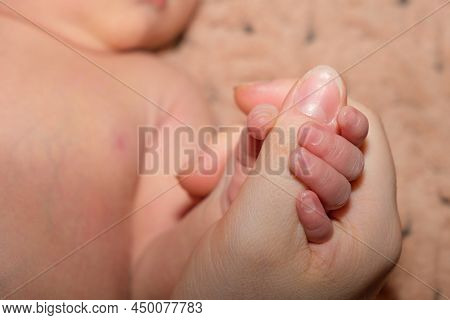 A Newborn Baby Holds Its Mothers Finger. Comfort And Affection, Firstborn, Parenthood