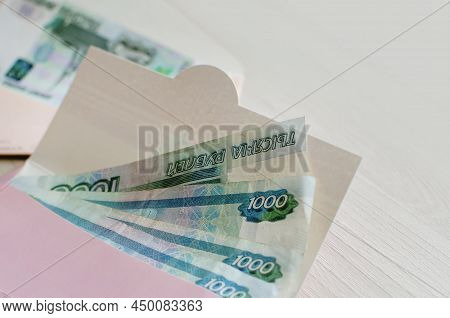 On The Table A Gift Envelope With A Russian Banknotes In Denominations Of One Thousand Rubles. Neutr