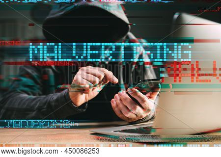Malvertising - Phone Hack And Attack Method Concept. Cyber Criminal Hacker Using Laptop And Smartpho