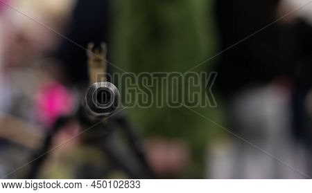 The Muzzle With The Sight Of An Army Assault Rifle Is Pointed At The Camera. Close-up Of The Weapons