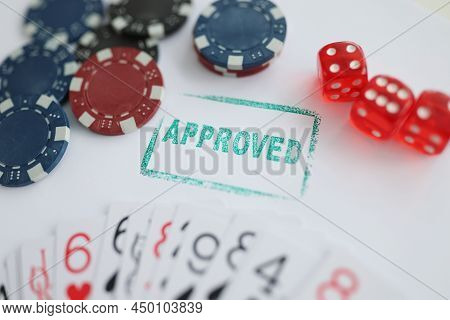 Close-up Of Stamp Approved Standing Near Playing Cards And Chips In Casino With Dice. Addiction, Pla