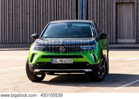 Riga, Latvia - 26 March, 2021: Green Electric Vehicle Opel Mokka-e In The Public Parking Lot, Future