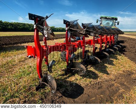 Bilogirya, Khmelnytsky Region, Ukraine - August 19, 2021: Tractor With Plow, Preparing The Field For