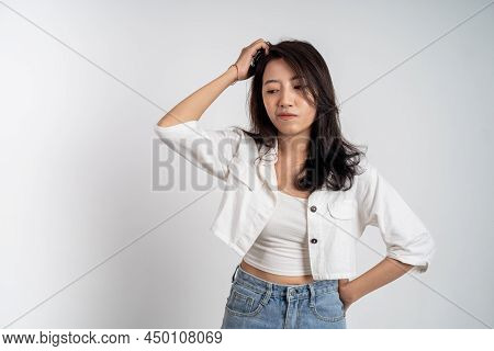 Sad Portrait Of Young Asian Woman Over Isolated Background