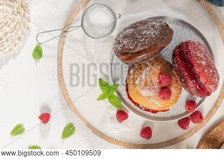 Bolas De Berlim, Or Berlin Balls. Portuguese Fried Dough With Sugar, Filled With Chocolate Or Raspbe