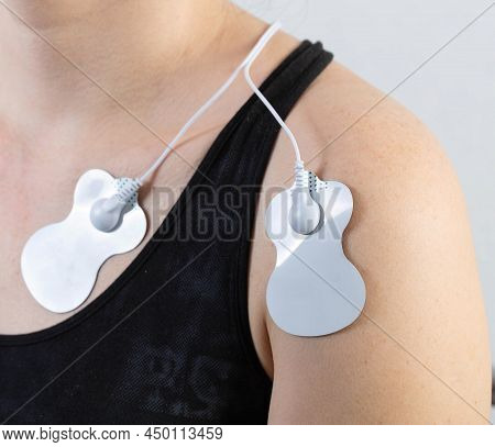 Medical Electric Acupuncture Massager On The Body Of A Girl. Fat Burning And Health Promotion. Physi