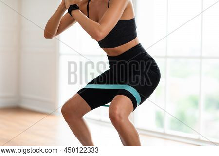 Closeup Of Woman In Black Sportswear Exercising With Elastic Band