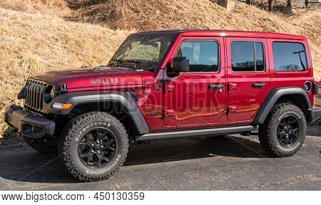 Monroeville, Pennsylvania, Usa February 27, 2022 A Red Four Door Used Jeep Wrangler For Sale On A Ca