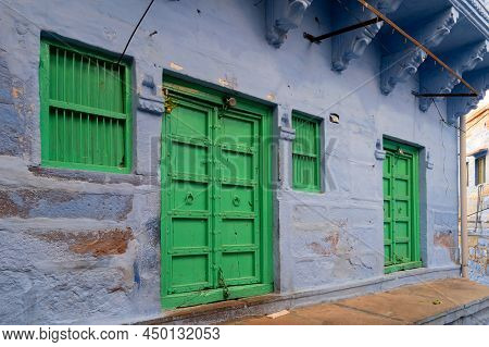 Traditional Blue Coloured House, Green Doors And Windows Of Jodhpur City, Rajsthan, India. Blue Is S