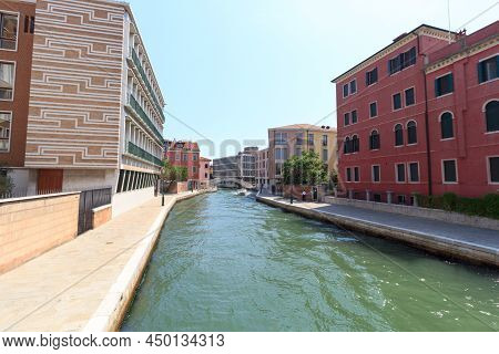 Channel With Boat And Modern Buildings In District Sestiere Santa Croce In Venice, Italy