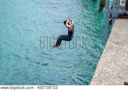 Tolaga Bay New Zealand - February 5 2022; Local Boys Jumping Of Tolaga Bay Wharf