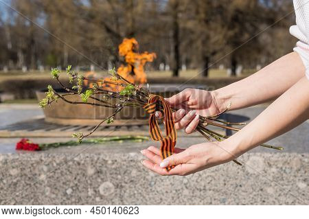 Victory Day Feast Of War White Flowers Lie On Eternal Flame. Commemoration Of Carnation Fire. Eterna