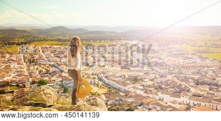 woman enjoying panoramic view of Spain city- Burguillos del Cerro