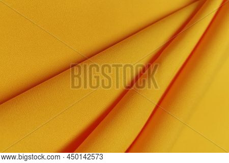 Yellow Crumpled Or Wavy Fabric Texture Background. Abstract Linen Cloth Soft Waves. Gabardine Wool F