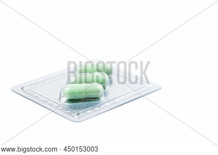 Green Chiretta Herbal Capsule On White Background With Copy Space For Healthcare And Medical Concept