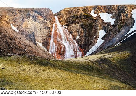 View Of Noname Waterfalls At The Cliff Of High Snow Covered Mountain In Summer Season In Highland, I