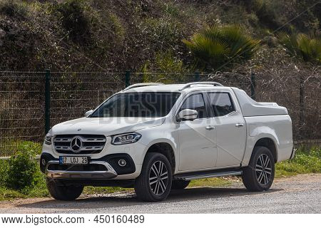 Side, Turkey - February 13 2022:  White Mercedes-benz  X-class   Is Parked  On The Street On A Warm 