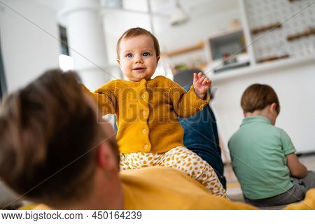 Unhappy Little Boy Feeling Jealous While Perent Spending Time With His Baby Sister At Home