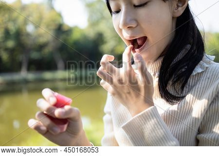 Asian Child Girl Maintains Her Lips,skin Care, Beauty And Protection, Chapped,dry Mouth That Have Lo