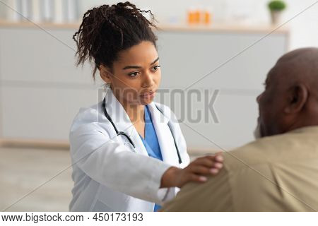 Close Up Of Black Female Doctor Tapping Patting Patients Shoulder
