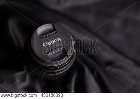 Kharkov, Ukraine - January 21, 2021: Canon Ef 85mm 1.8 Lens On Black Fabric Background. Detailed Pho