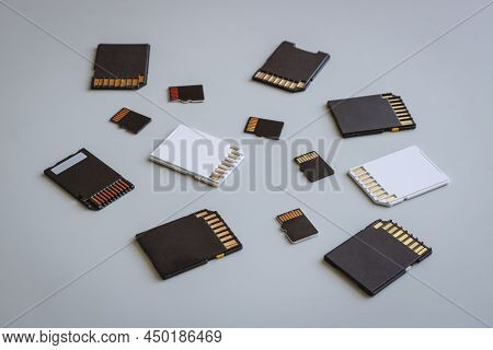 Sd And Microsd Memory Cards On A Neutral Gray Background.