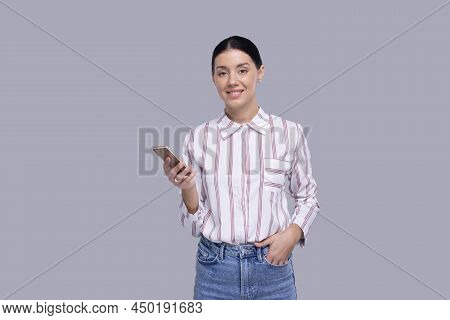 Girl Holding Phone Standing Looking Ot Camera Isolated. Commecial, Shopping, Advertisment Concept
