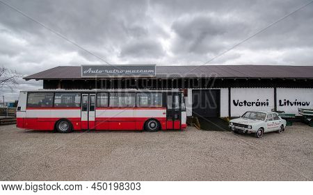 Litvinov, Czechia - February 08, 2022: Red Bus Of Karosa C 735 And White Car Of Skoda 105 In Front O